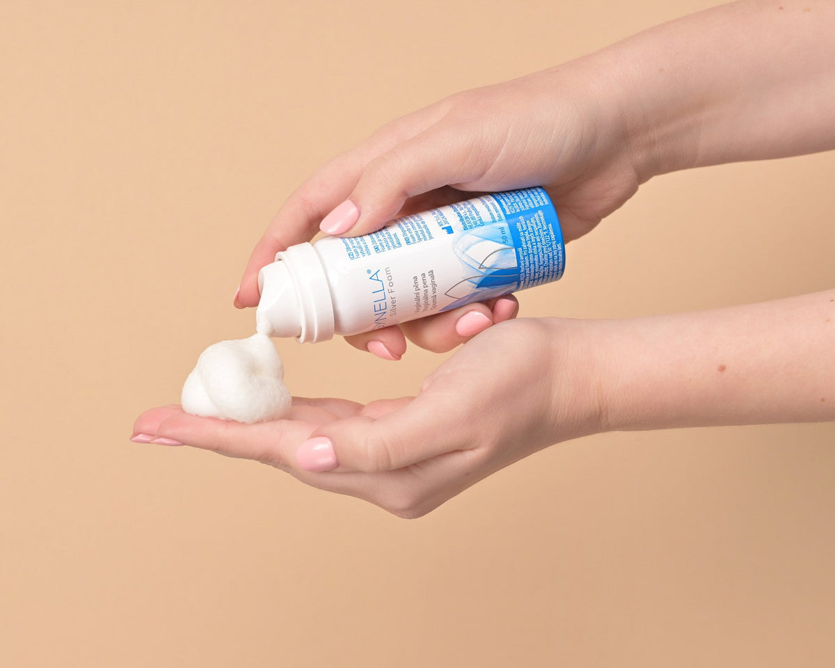 Pregnant woman holding Gynella Silver Foam bottle