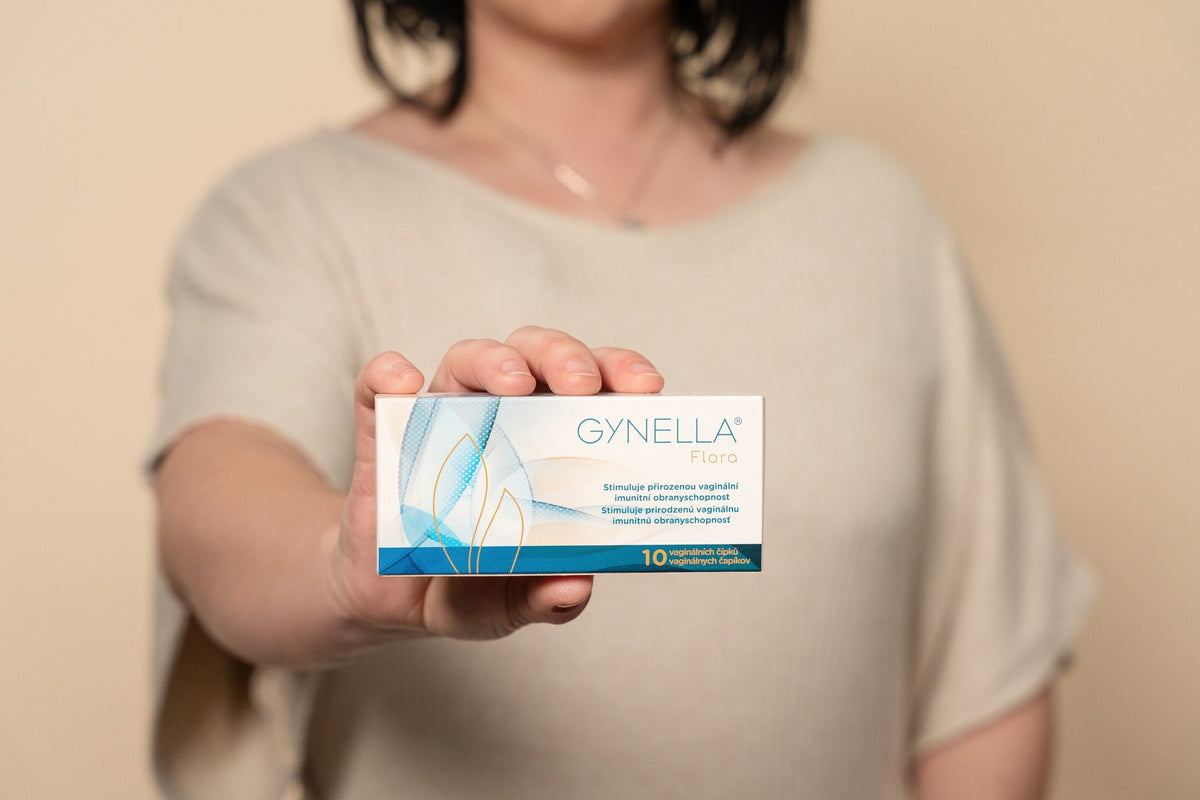 Woman showing Gynella Flora box
